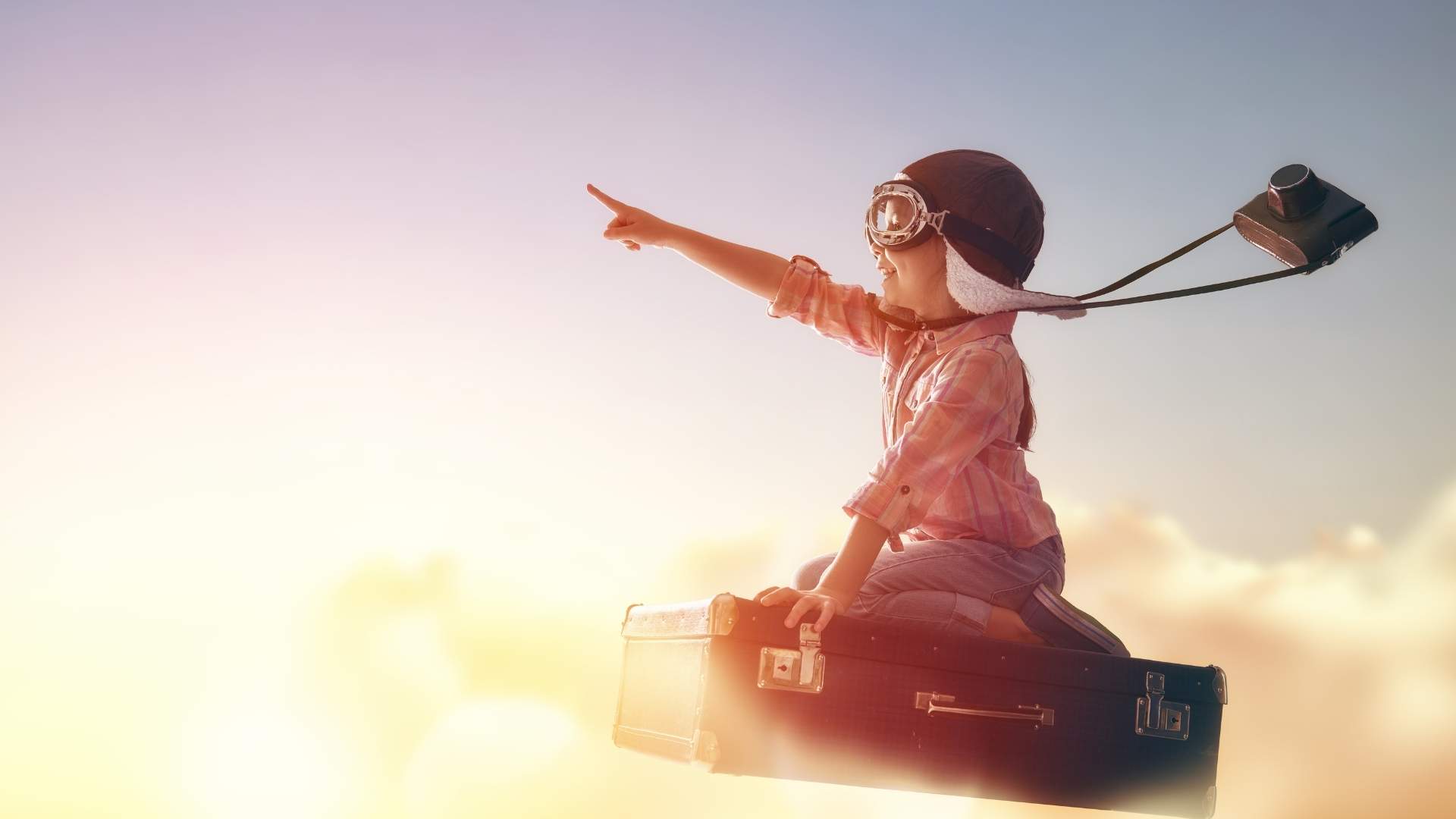 boy on flying suitcase with big dreams of the future