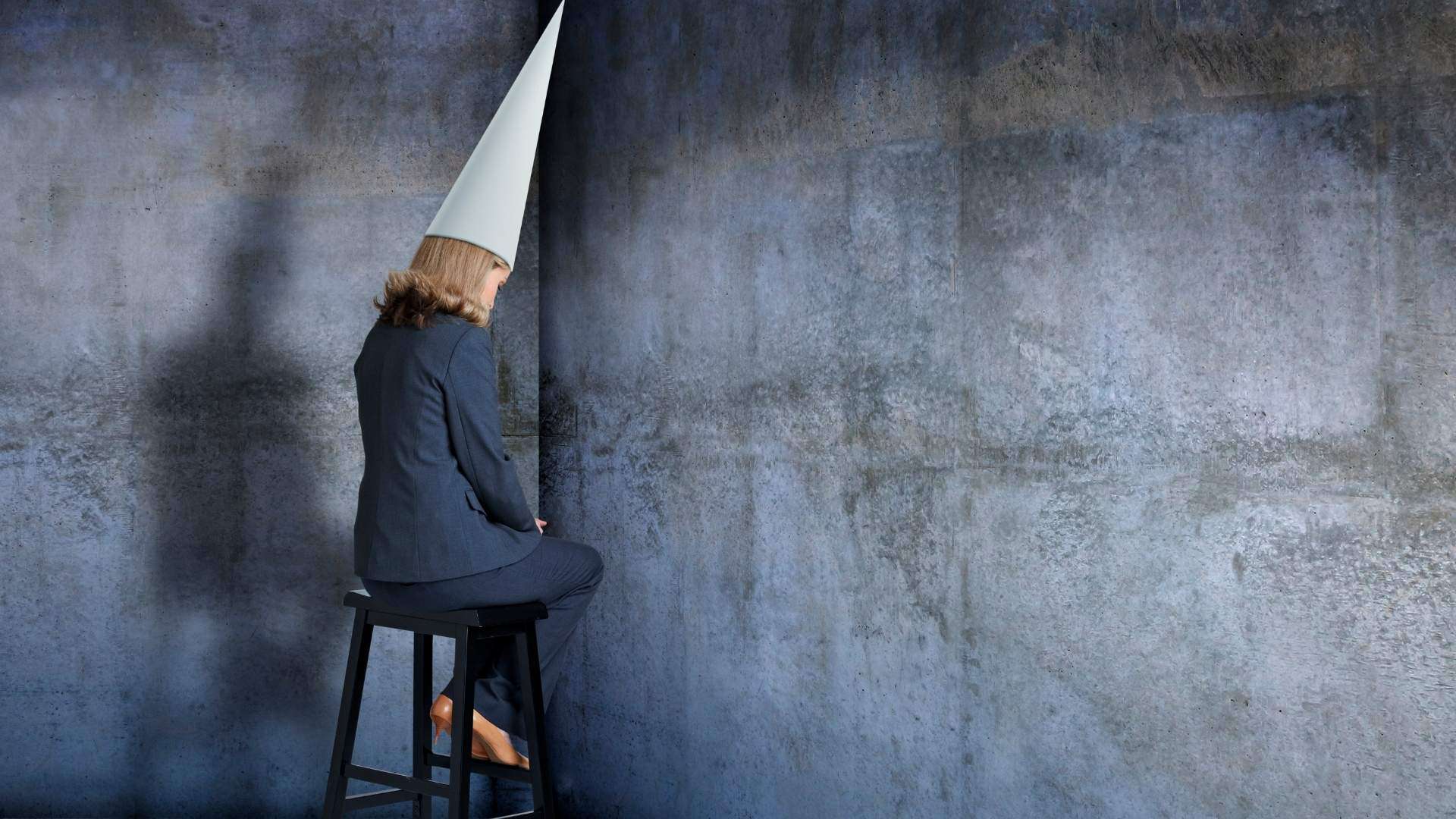 woman sitting in corner wondering if God is punishing her