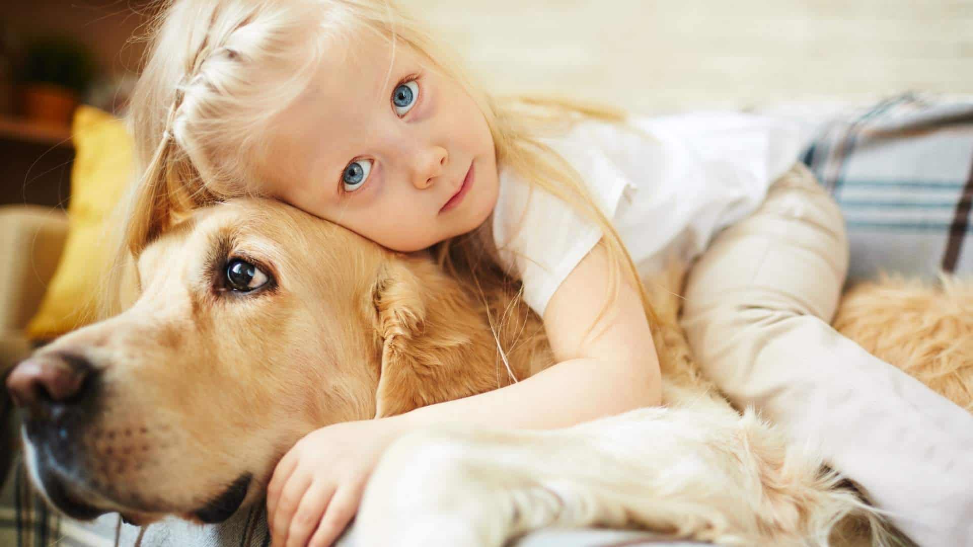 girl cuddling her dog