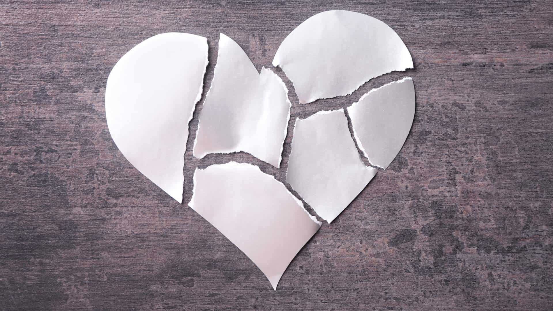 torn paper heart representing being crushed by heartbreak.