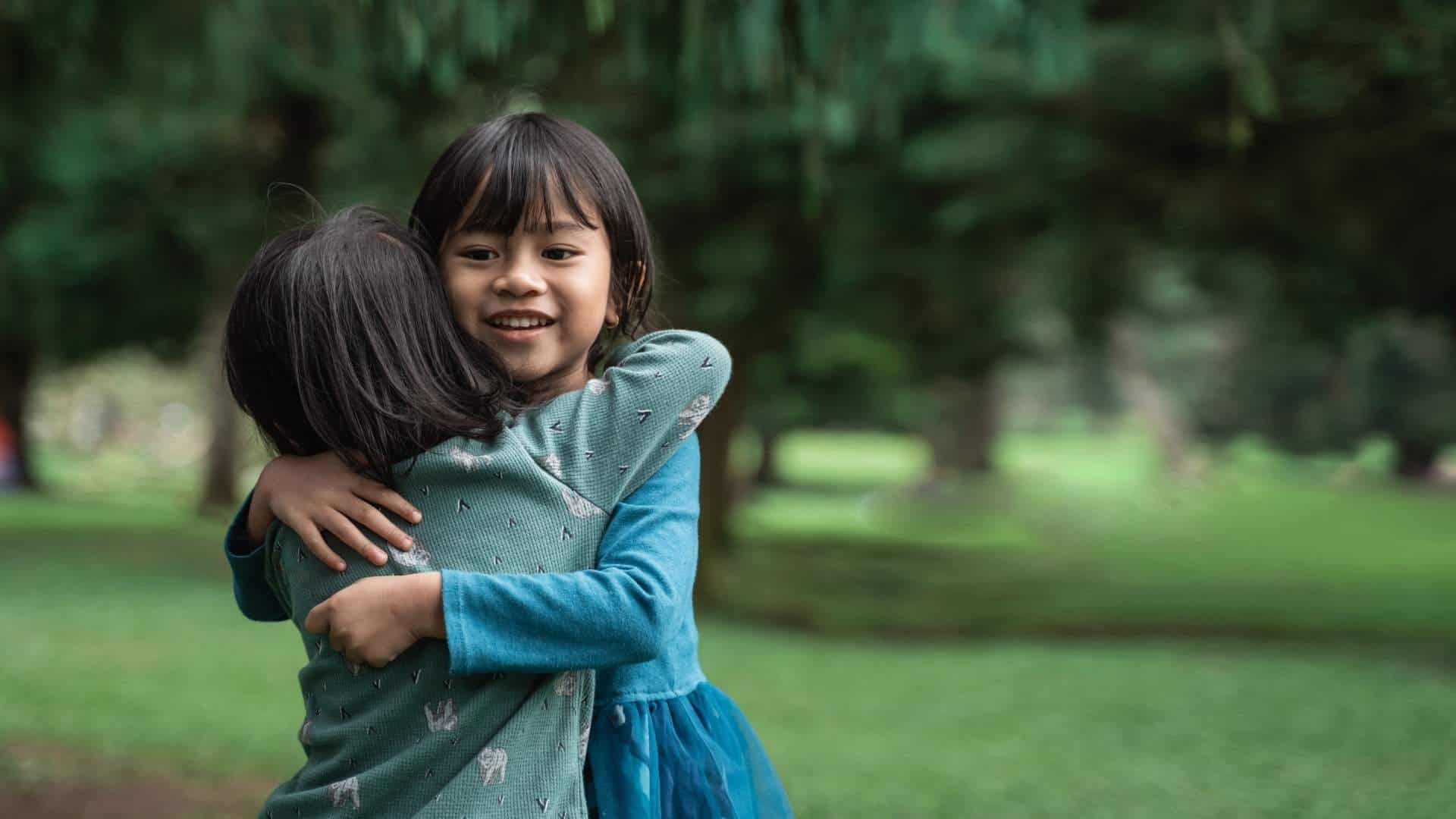 two girls hugging representing love giving us our greatest hope