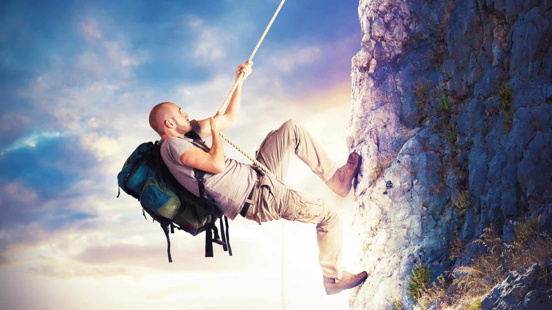 man climbing a mountain