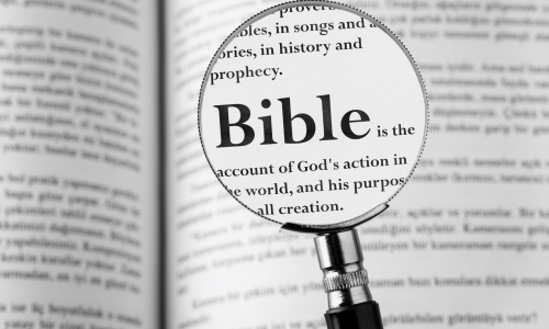 Bible and magnifying glass