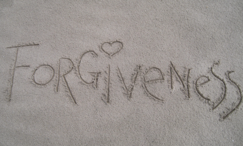 Forgiveness written in sand