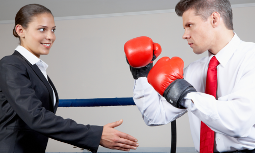 Woman trying to shake hands with boxer