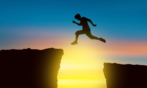 boy jumping a cliff