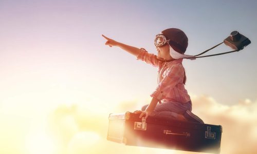 boy on flying suitcase with big dreams of the future