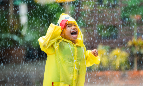 boy playing in rain