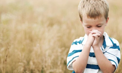 Boy praying to God