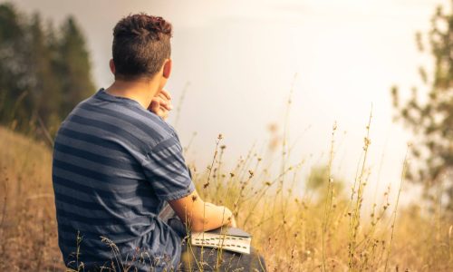 boy-with-bible-in-field