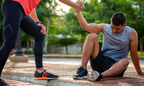 fallen runner being helped up
