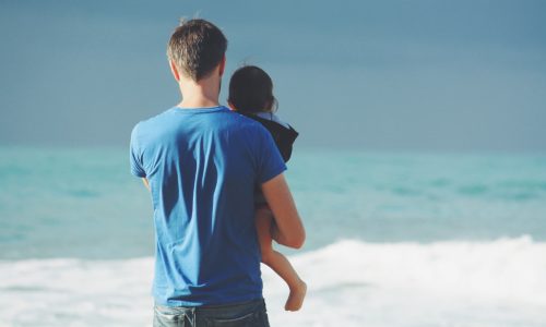 father-with-child-at-ocean