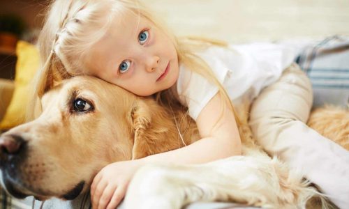 girl cuddling her dog