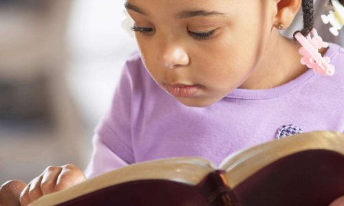 girl reading the bible to keep her soul continually satisfied