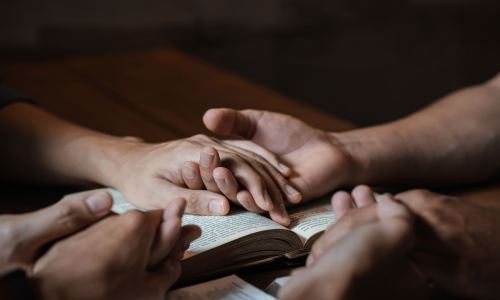 holding hands in prayer