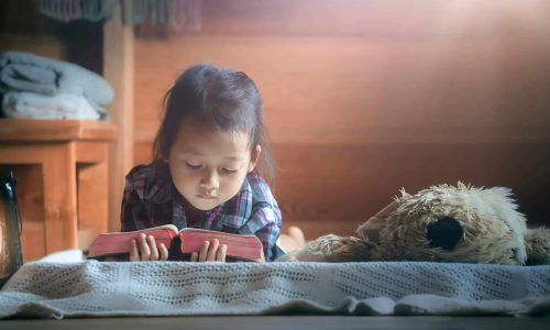 little girl reading bible