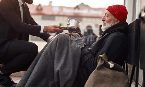 man giving to homeless man