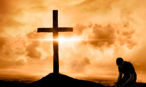 man kneeling before cross