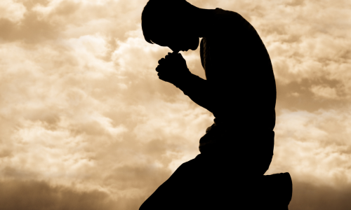 man on knees in prayer