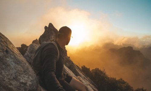 man on top of mountain