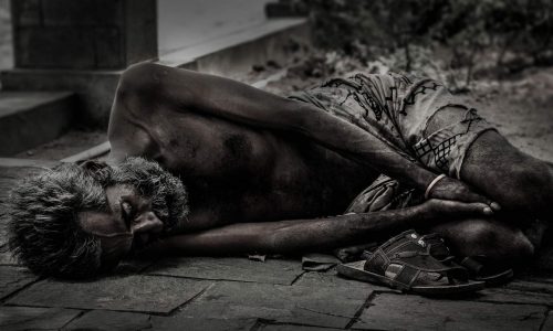 poor man laying in street