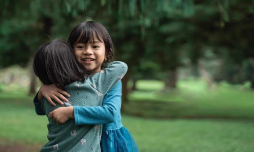 two girls hugging representing love giving us our greatest hope