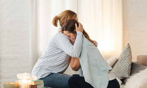 woman comforting a crying woman