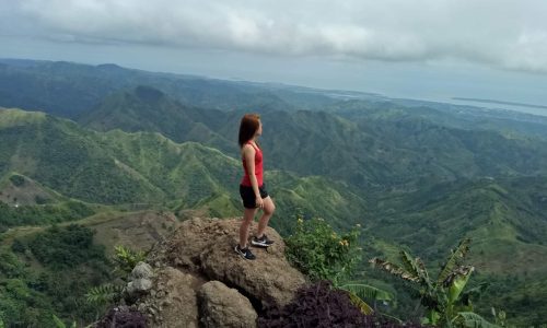 woman-on-top-of-mountain satisfied with life