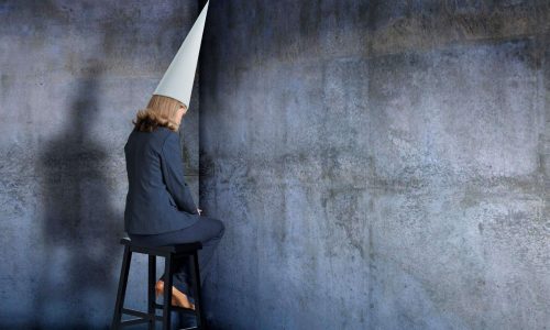 woman sitting in corner wondering if God is punishing her